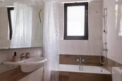 a bathroom with a tub and a sink and a shower at Gallery7B in Ialyssos