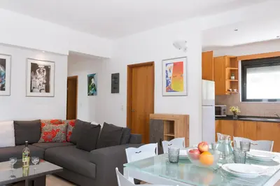 a living room with a couch and a table at Gallery7B in Ialyssos