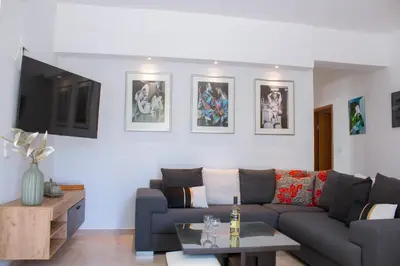 a living room with a couch and a table at Gallery7B in Ialyssos
