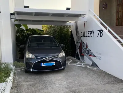 a car is parked under a car garage at Gallery7B in Ialyssos