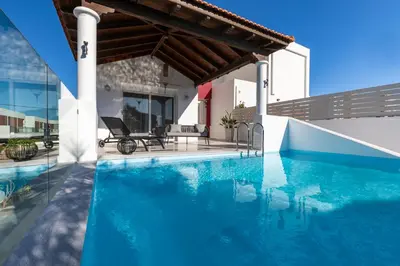 a villa with a swimming pool and a house at Elena House in Gennadi