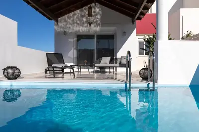 a villa with a swimming pool and a house at Elena House in Gennadi