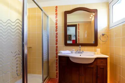 a bathroom with a sink and a shower at Elena House in Gennadi
