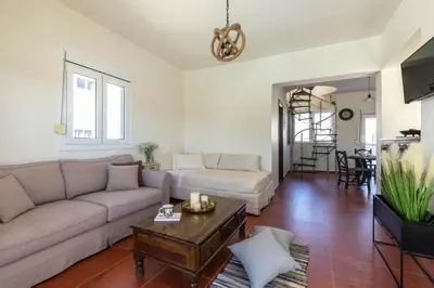 a living room with a couch and a table at Elena House in Gennadi