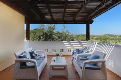 a patio with two couches and a table at Seven Springs Villas in Kolimbia