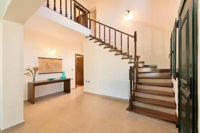 a hallway with a staircase in a house at Seven Springs Villas in Kolimbia