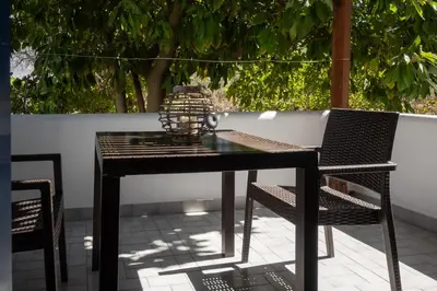 a black table and chairs on a patio at Triantafillas Suites in Afantou