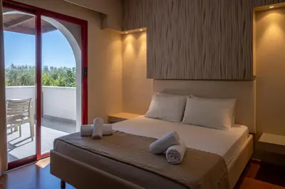 a bedroom with a bed with towels on it at Triantafillas Suites in Afantou