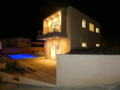 a house at night with the lights on at Louloudi Hills Villa 3 in Koskinou
