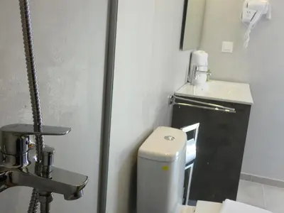 a small bathroom with a toilet and a sink at Louloudi Hills Villa 3 in Koskinou