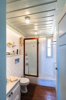 a bathroom with a shower with a toilet and a sink at Villa Melograno HALKI in Halki