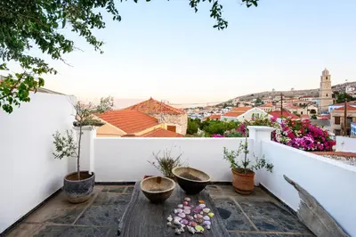 a balcony with a view of a city at Villa Melograno HALKI in Halki