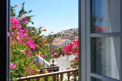 a view from a window of flowers at Villa Melograno HALKI in Halki
