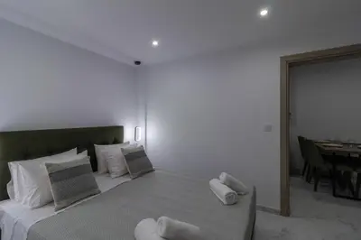 a bedroom with a large bed with white pillows at Melia Luxury Villa in Kolimbia