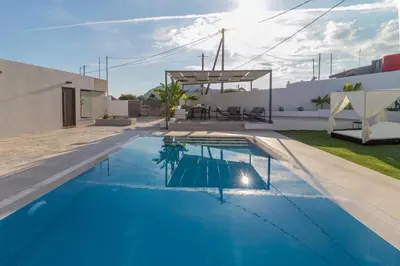 a swimming pool in the backyard of a house at Melia Luxury Villa in Kolimbia