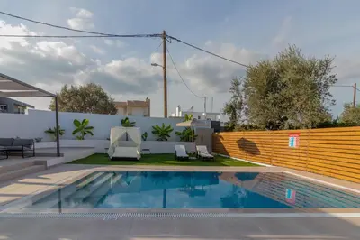 a swimming pool in the backyard of a house at Melia Luxury Villa in Kolimbia