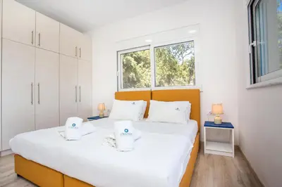 a bedroom with a bed and a window at Louloudi Hills Villa 1 in Koskinou