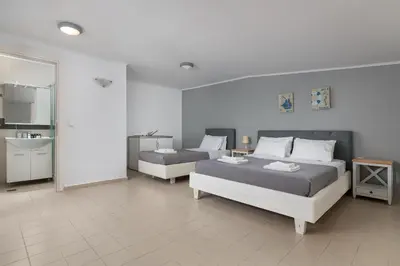 a bedroom with two beds and a bathroom at Modern Luxury Villa in Rhodes Town