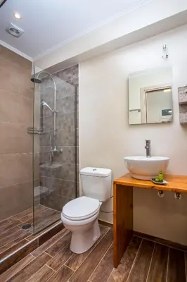 a bathroom with a toilet and a sink and a shower at Louloudi Hills Villa 2 in Koskinou