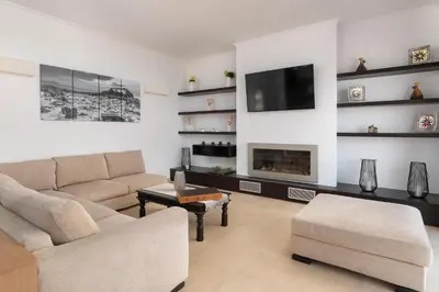 a living room with a couch and a fireplace at Vitzi Vista Villa in Rhodes Town