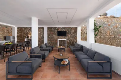a waiting room with couches and chairs and a fireplace at Vitzi Vista Villa in Rhodes Town