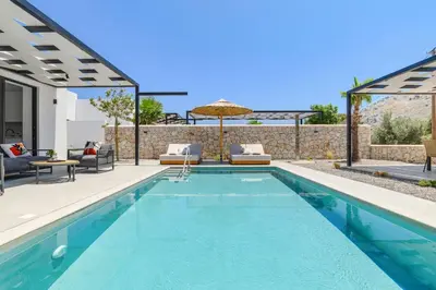 a swimming pool in a villa with a patio at Villa Zen Roshi by Villa Plus in Kolimbia