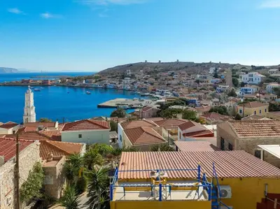 a view of a city with a harbor and water at Yellow Oasis traditional home with sea view in Halki
