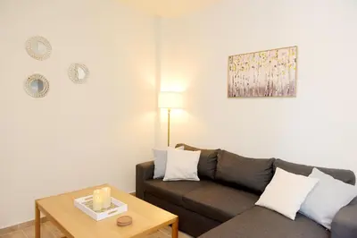 a living room with a couch and a table at Square home in Émbonas