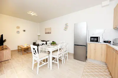 a kitchen and dining room with a table and a refrigerator at Square home in Émbonas