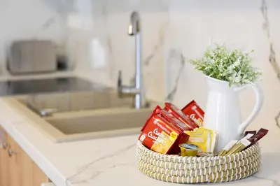 a basket of food and a vase of flowers on a counter at Square home in Émbonas