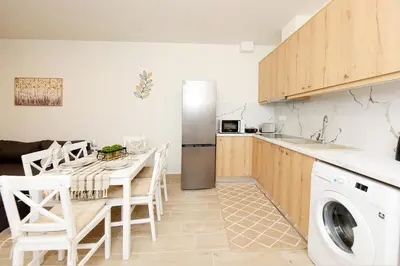 a kitchen with a table and a washing machine at Square home in Émbonas