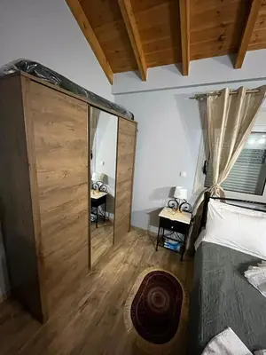 a bedroom with a bed and a glass wall at Blue waves house 1 in Rhodes Town