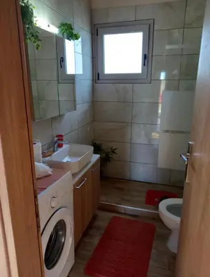 a bathroom with a sink and a washing machine at Blue waves house 1 in Rhodes Town