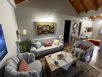 a living room with two couches and a table at Blue waves house 1 in Rhodes Town