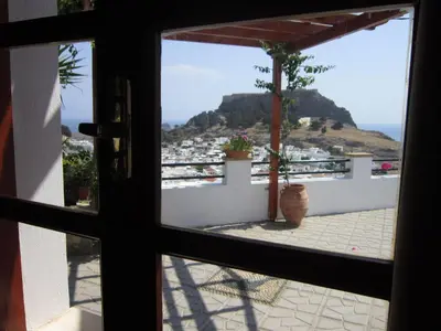 a view from a window looking out at the ocean at Chrysa Studios in Líndos