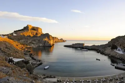 a view of a body of water with a mountain at Chrysa Studios in Líndos