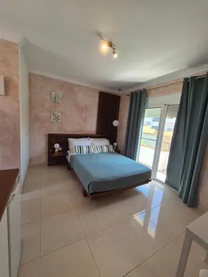 a bedroom with a bed and a large window at Ninas Room in Rhodes Town