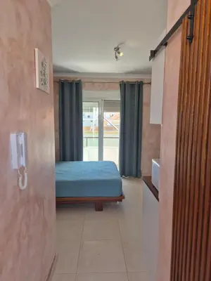 a bedroom with a bed in a room with a door at Ninas Room in Rhodes Town