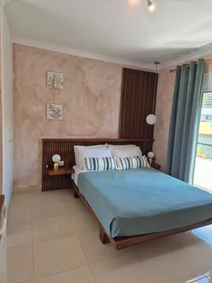 a bedroom with a large bed with blue sheets at Ninas Room in Rhodes Town