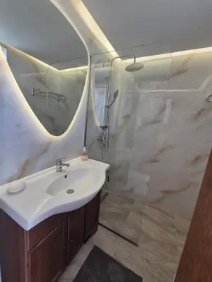 a bathroom with a white sink and a shower at Ninas Room in Rhodes Town