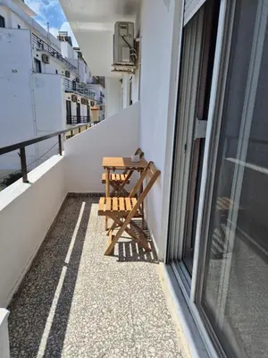 a balcony with a table and chairs on a building at Ninas Room in Rhodes Town