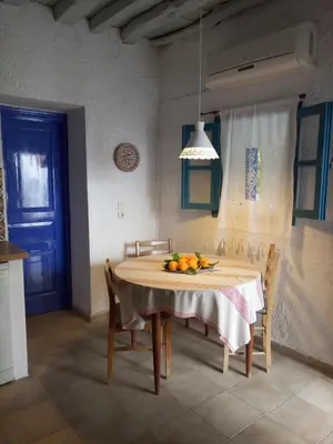 a kitchen with a table with a bowl of fruit on it at Rhodes Summer House in Gennadi