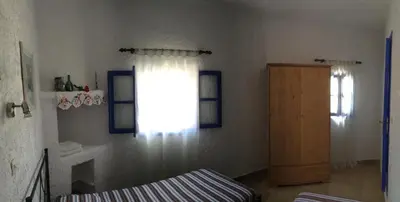a bedroom with a window and a bed and a door at Rhodes Summer House in Gennadi
