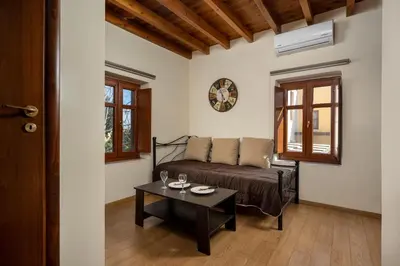 a living room with a couch and a table at 3 Charites Old Town in Rhodes Town