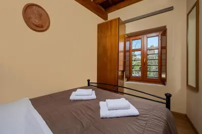 a bedroom with a bed with two towels on it at 3 Charites Old Town in Rhodes Town