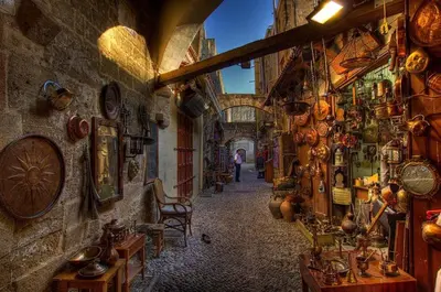 an alleyway in an old building with a lot of items at 3 Charites Old Town in Rhodes Town