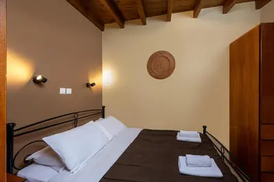 a bedroom with a bed with two towels on it at 3 Charites Old Town in Rhodes Town