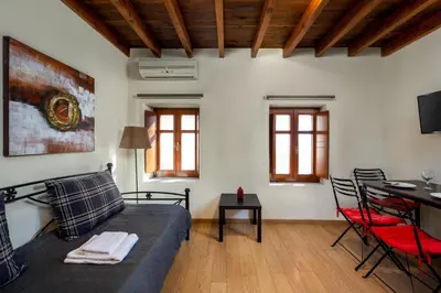 a living room with a couch and a table at 3 Charites Old Town in Rhodes Town