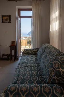 a bedroom with a bed and a large window at Villa Elizabeth in Symi