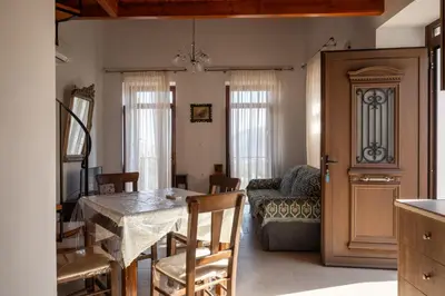 a kitchen and dining room with a table and chairs at Villa Elizabeth in Symi